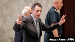 Nizar Zakka flashes a victory gesture in Beirut hours after being released from Iranian captivity on June 11. 