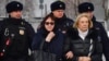 Lyudmila Navalnaya (the woman wearing glasses), mother of late Russian opposition leader Alexei Navalny, accompanied by Alla, mother of Navalny's widow Yulia, leaves after visiting the grave of her son at the Borisovo cemetery in Moscow on March 2, 2024, 