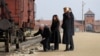 U.S. Vice President Mike Pence (kneeling), with wife Karen, and Polish President Andrzej Duda at the Nazi's Auschwitz extermination camp.