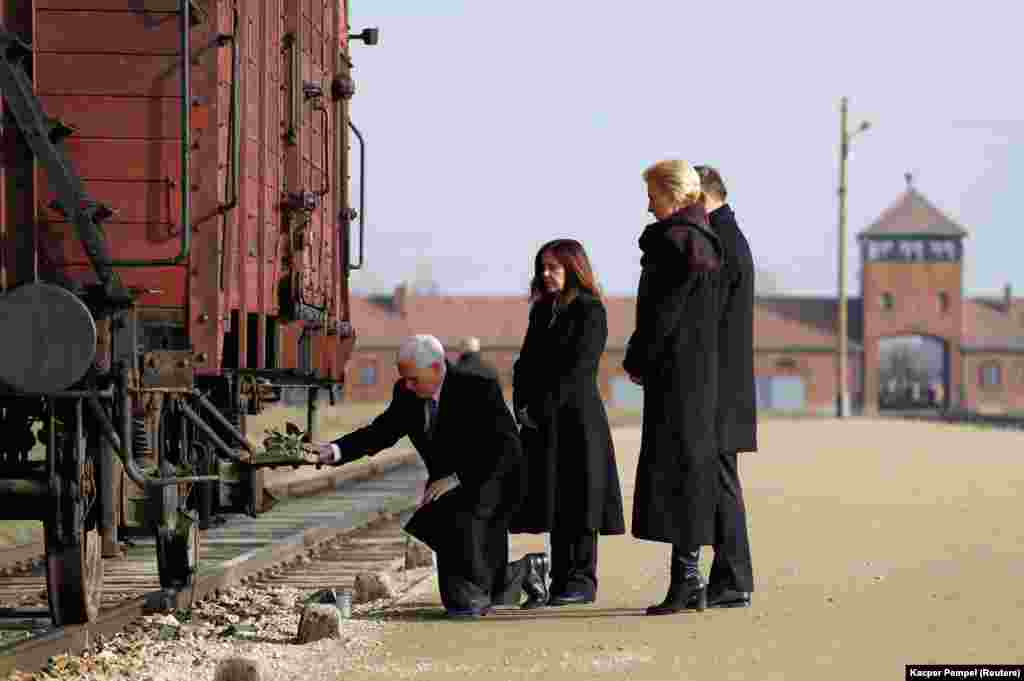 U.S. Vice President Mike Pence with his wife, Karen, and Poland&#39;s President Andrzej Duda with first lady Agata Kornhauser-Duda lay flowers on a train wagon as they visit the former Nazi German concentration and extermination camp Auschwitz II-Birkenau, near Oswiecim, Poland. (Reuters/Kacper Pempel)