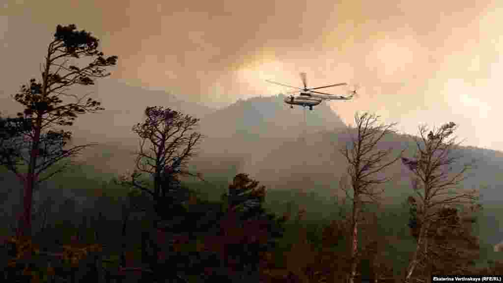 File image of a helicopter fighting a blaze near Lake Baikal. According to a recent&nbsp;scientific study, fires are the reason Siberia is steadily losing its conifer trees. The more adaptable trees that replace the charred conifers dry out the landscape, further increasing the risk of summer wildfires.&nbsp;