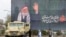 IRAN - Women walk past an Iranian security forces vehcile parked under a banner honoring Irans slain supreme leader Ayatollah Ali Khamenei, Tehran, March 31, 2026. 
