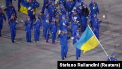 SOUTH KOREA -- Olena Pidhrushna of Ukraine carries the national flag during the Olympic Opening ceremony reception in Pyeongchang, February 9, 2018