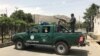 An Afghan police officer keeps watch near the site of a suicide bombing in Kabul on June 4.