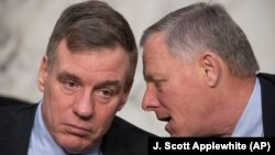 U.S. -- Senate Intelligence Committee Vice Chairman Mark Warner (L) and Chairman Richard Burr hold a hearing to examine efforts to secure state election systems and to safeguard against foreign meddling in this year's elections, on Capitol Hill in Washing