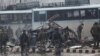 Indian security forces inspect the remains of a vehicle following a bomb attack in Kashmir on February 14.