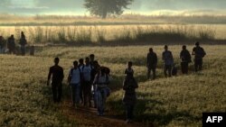 Grupa izbeglica i migranata na granici Severne Makedonije i Grčke. Balkanska ruta, preko koje izbeglice i migranti, bežeći od rata i siromaštva, pokušavaju da se domognu država Evropske unije aktivna je od 2015. godine. 