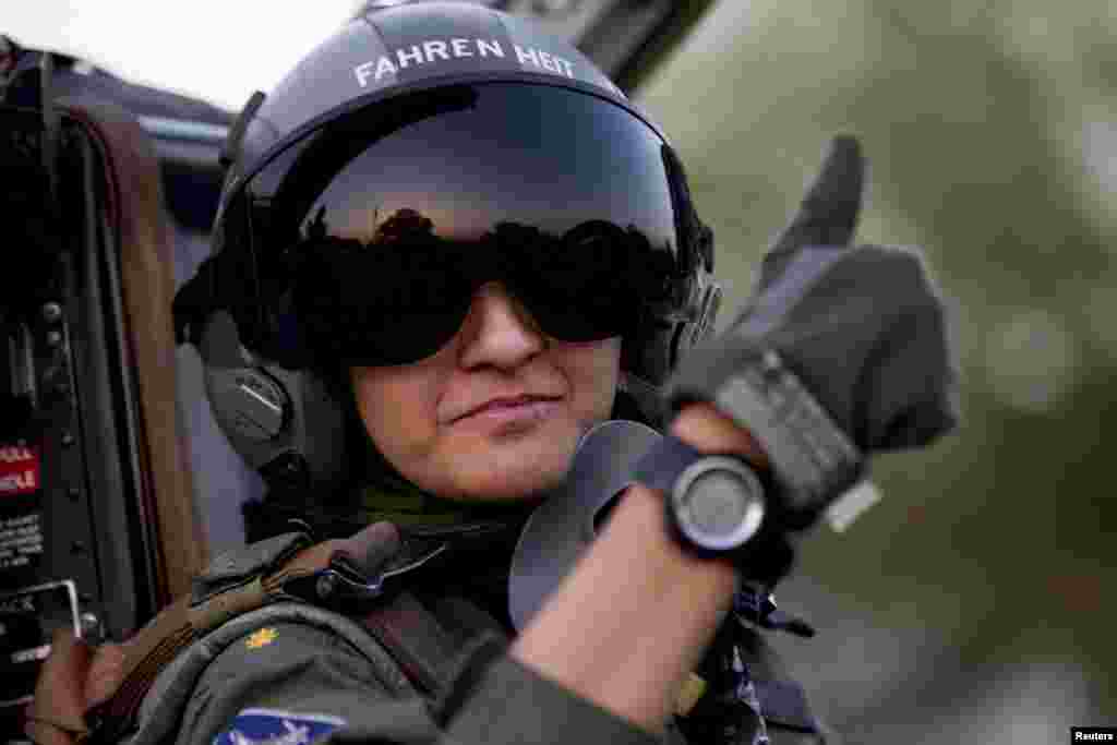 Ayesha Farooq gives the thumb-up sign from the cockpit of a Chinese-made F-7PG fighter jet at Mushaf base in Sargodha