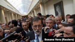 Шпанскиот премиер Маријано Рахој со новинарите по пленарната седница во Сенатот на горниот дом во Мадрид