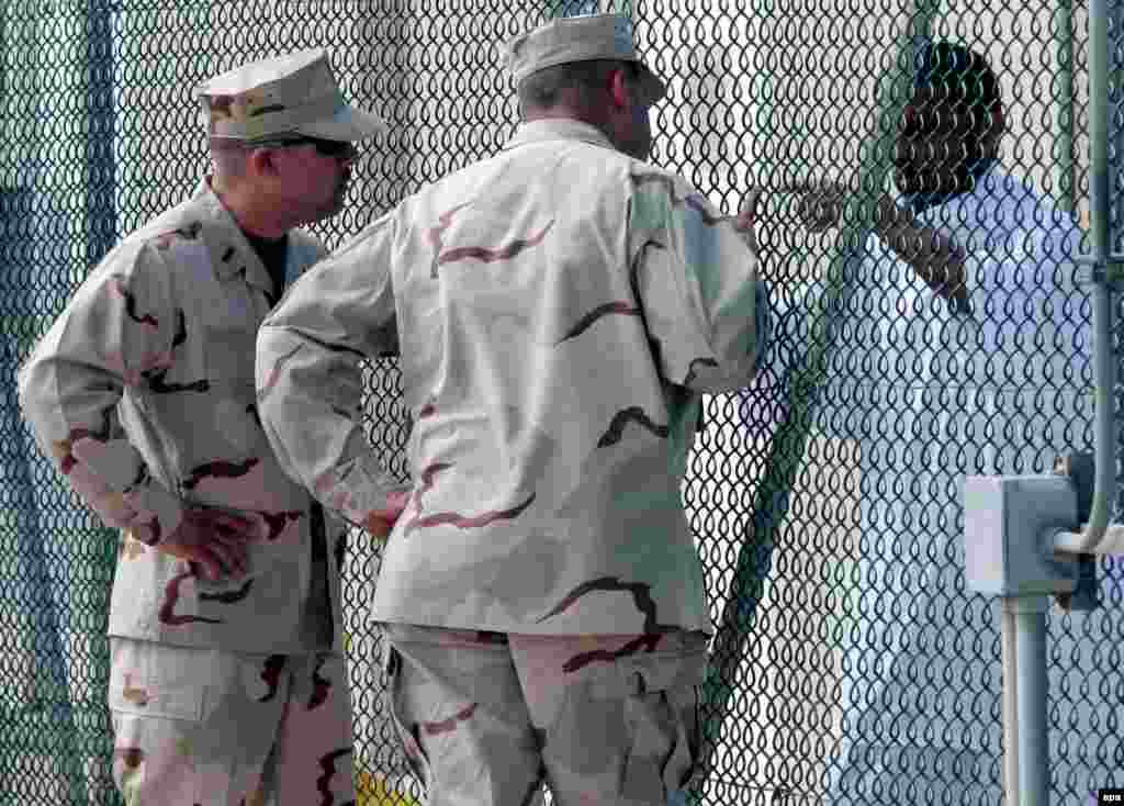 U.S. guards talk to a prisoner at Guantanamo Bay.