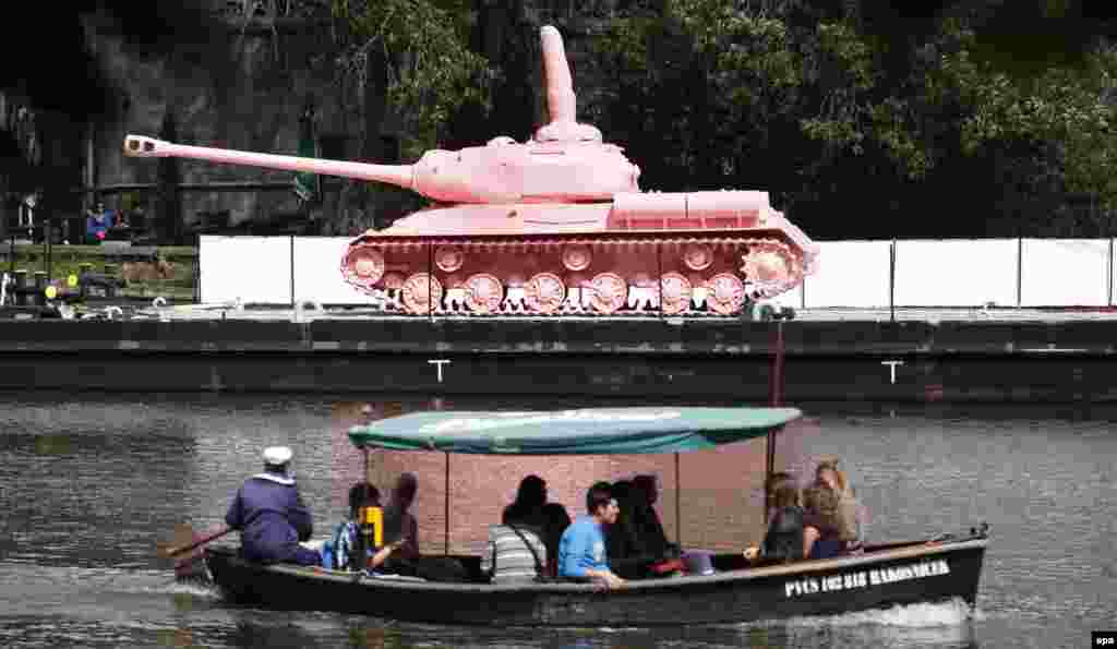Czech Republic -- Pink painted tank by Czech artist David Cerny is seen on the boat at Vltava river in Prague, Czech Republic, 20 June 2011.