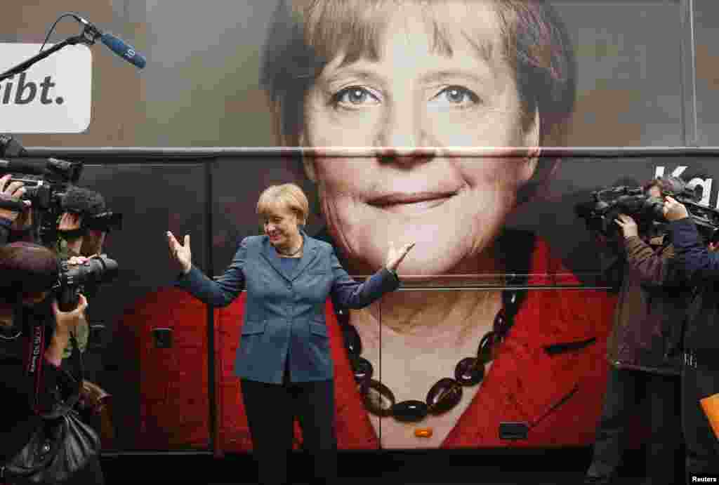 Merkel stands in front of her election campaign tour bus before a CDU board meeting in Berlin in September 2013.