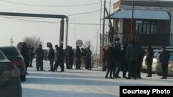 Miners and their relatives gather at the entrance to a mine in Kazakhstan's Qaraghandy region where workers have gone on strike.