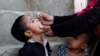 PAKISTAN -- A boy receives polio vaccine drops, during an anti-polio campaign, in a low-income neighbourhood in Karachi, April 9, 2018