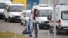 A medical specialist wearing protective gear accompanies a man outside a hospital for patients infected with the coronavirus disease on the outskirts of Moscow on October 7.