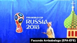 RUSSIA -- A woman walks past a banner promoting the FIFA World Cup 2018 in Moscow, June 13, 2018