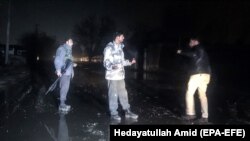 Afghan security personnel inspects the site of a car bomb blast which targeted a British security contractor group (G4S) in Kabul on November 28.