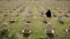 A Kurdish woman visits the graves of her relatives who were killed in the gas attack in 1988 on the 24th anniversary of the attack at the memorial site to the victims in the Iraqi town of Halabja.