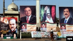 A cyclist passed an election billboard outside the Punjab provincial assembly in Lahore, Pakistan, on March 2.