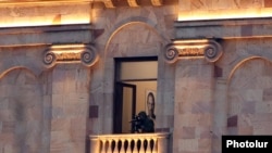 Armenia -- A security service officer monitors an opposition demonstration from the Armenian parliament building, Yerevan, March 3, 2021.