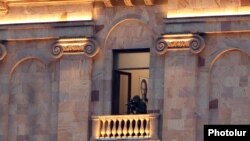 Armenia -- A security service officer monitors an opposition demonstration from the Armenian parliament building, Yerevan, March 3, 2021.