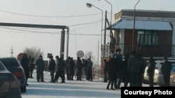 Miners and their relatives gather at the entrance to a mine in Kazakhstan's Qaraghandy region where workers have gone on strike.