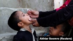 A boy receives polio vaccine drops in Karachi on April 9