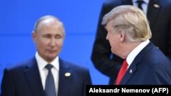 U.S. President Donald Trump (right) looks at Russian President Vladimir Putin as they take their places for a photo during the G20 summit in Buenos Aires on November 30.