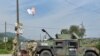 FILE PHOTO: Members of the KFOR peacekeeping force patrol the area near the border crossing between Kosovo and Serbia in Jarinje