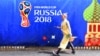 A woman walks past a banner promoting the FIFA World Cup 2018 in Moscow.