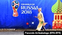 A woman walks past a banner promoting the FIFA World Cup 2018 in Moscow.