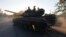 Ukrainian servicemen ride a tank in the southern coastal town of Mariupol on September 5.