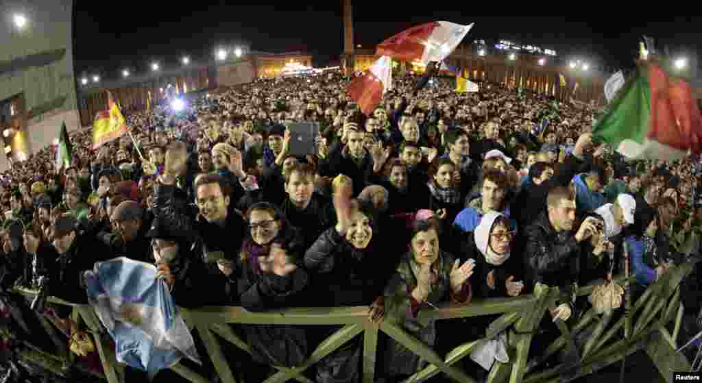 Faithful cheer as newly elected Pope Francis appears on the balcony of St. Peter&#39;s Basilica at the Vatican.