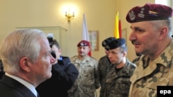 U.S. Defense Secretary Robert Gates (left) meets with Polish soldiers after signing a memorandum on cooperation between the Polish and U.S. militaries in Krakow.