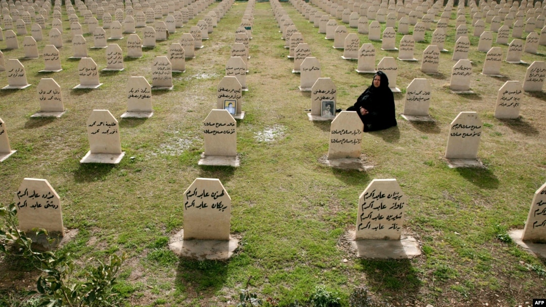 A Kurdish woman visits the graves of her relatives who were killed in the gas attack in 1988 on the 24th anniversary of the attack at the memorial site to the victims in the Iraqi town of Halabja.