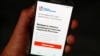 The Smart Voting or "Navalny" app is seen on an iPhone screen in Moscow.