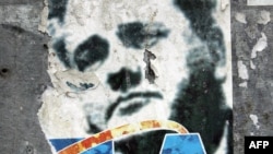 Serbia - A ripped poster of former Yugoslav President Slobodan Milosevic is seen in central Belgrade, 05 October 2005