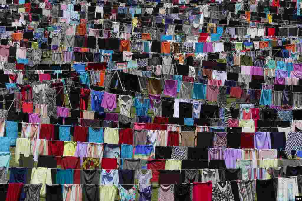 A view of the art installation called Thinking Of You in Pristina, Kosovo. In the installation, thousands of women's dresses and skirts hang on clotheslines, dedicated to the survivors of sexual violence during the 1998-99 Kosovo war. (epa/Valdrin Xhemaj)