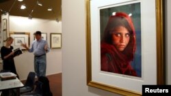 The famous portrait of Sharbat Gula is shown displayed at an art fair in Sydney, Australia, in 2005.