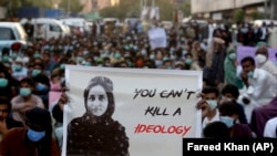 Protesters hold up portraits of Baluch political activist Karima Baloch in Karachi on December 24, 2020.