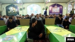 Mourners attend an Iranian funeral of Afghan fighters killed in Syria.