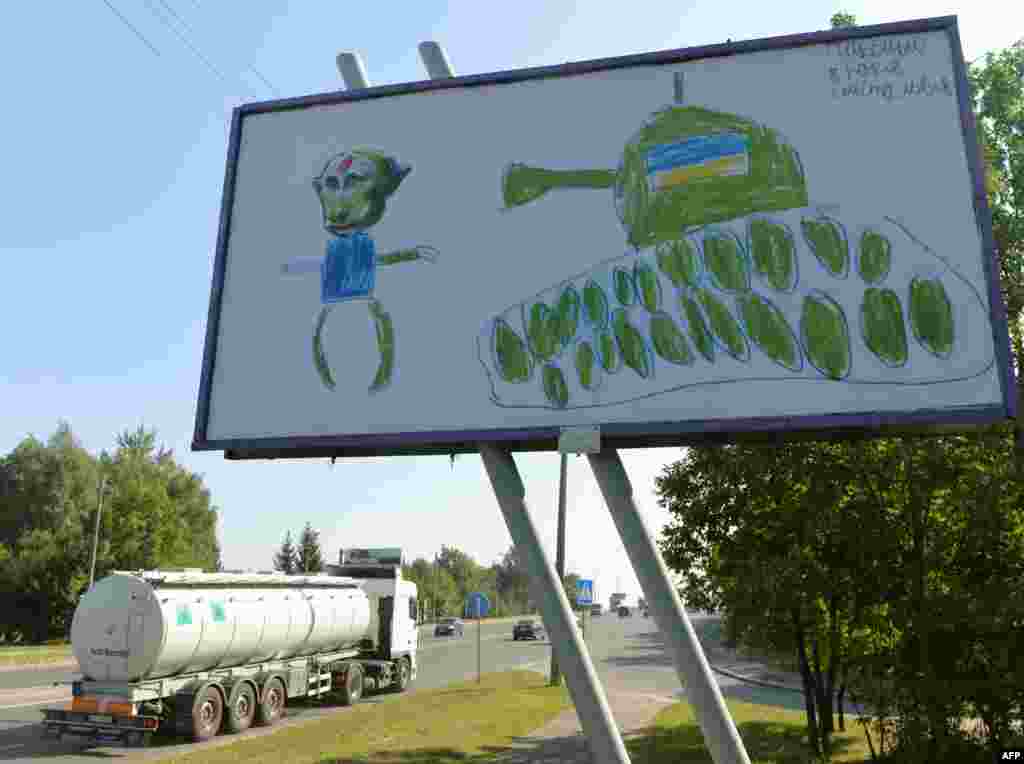 A drawing by an 8-year old Ukrainian boy, Maksim, depicting Russian President Vladimir Putin and an Ukrainian tank, is displayed on a billboard in the western city of Lviv. (AFP/Yurko Dyachyshyn)