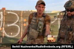 Andriy demonstrates an ML-8 "anti-lift" device designed to detonate a mine as it is being removed.