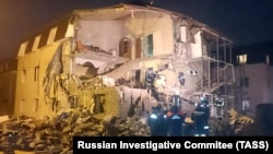 Rescuers work at the site of a partially collapsed residential building after a gas explosion in the Siberian city of Krasnoyarsk late on February 14.