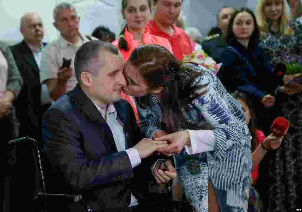 Wounded Ukrainian officer Oleksandr Darmoros kisses his bride, Elena, during their wedding in the central military hospital in Kyiv. Oleksandr was wounded during fighting with Russia-backed militants in eastern Ukraine. He lost his vision and foot after detonating a mine. (epa/Serhey Dolzhenko)