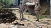 Police officers inspect parts of a projectile attached to drone intercepted by the Indian Army in Wadala Bhattewad village near Amritsar, India, on May 10
