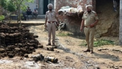 Police officers inspect parts of a projectile attached to drone intercepted by the Indian Army in Wadala Bhattewad village near Amritsar, India, on May 10