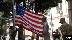 U.S. soldiers lower th flag at a memorial ceremony in honour of the 15th anniversary of the September 11, 2001 attacks in Kabul.