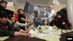 Members of a local electoral commission empty a ballot box for counting at a polling station in Sevastopol, in Crimea, Ukraine, on March 16.