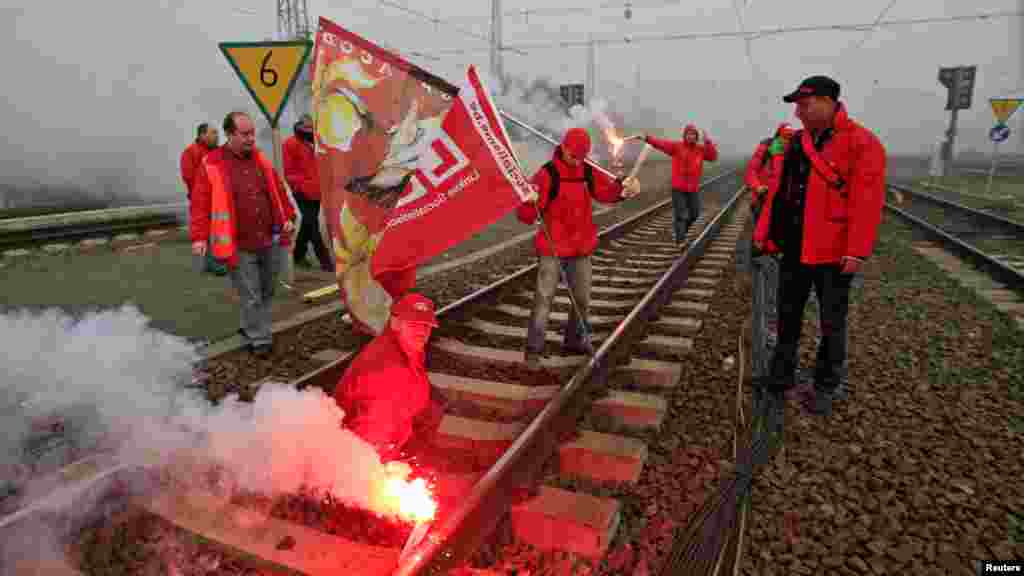 Belgian workers block trains as they demonstrate in Brussels.